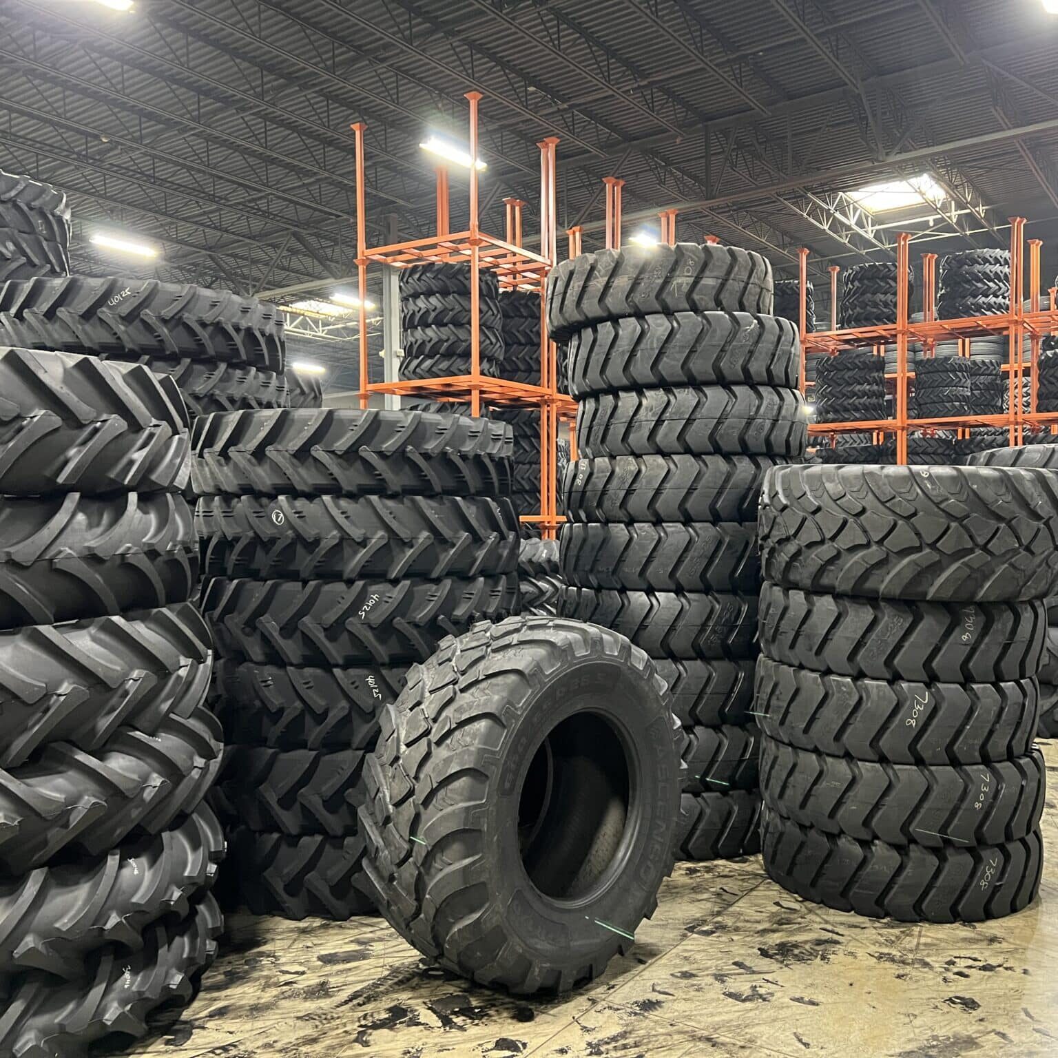 Factory direct OTR tires stacked, ready for wholesale distribution to dealers and heavy equipment operators